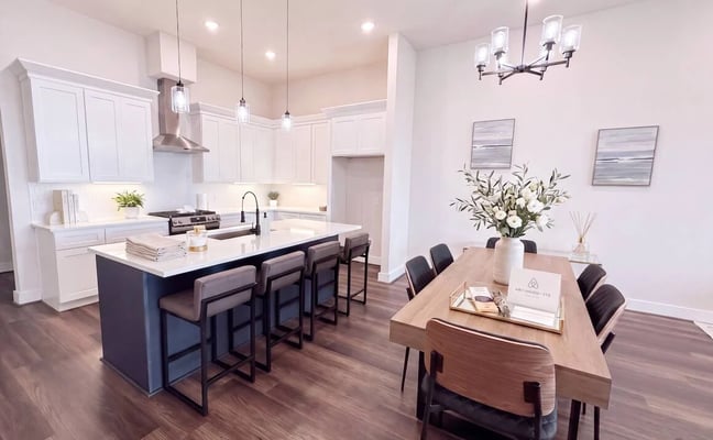Modern open kitchen and dining room with island seating and hardwood floors